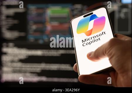 New York, USA - April 20, 2026: Testing Microsoft Copilot Ai service on smartphone screen in programmer background Stock Photo