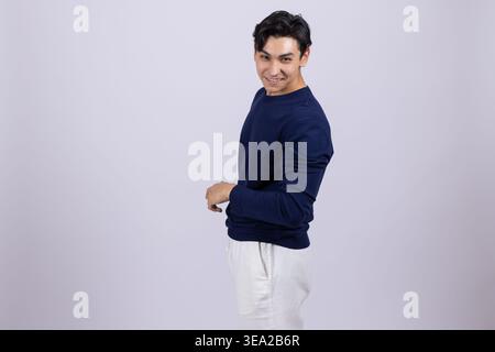 Side view of a young man looking back over his shoulder Stock Photo