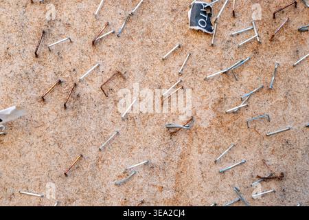 Metallic staples on a weathered notice board The Concept of past events Stock Photo