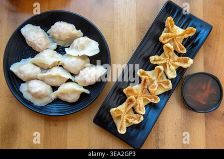 Shrimp paste boiled dumpling (left) and Cheese crab puffs at Dumpling World, Austin, Texas, September 30, 2024. (Photo by John Anderson) Stock Photo