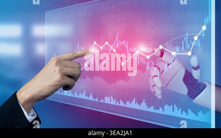 A hand interacts with a robotic arm on a digital screen displaying vibrant data graphs, illustrating the fusion of technology and finance in a modern Stock Photo