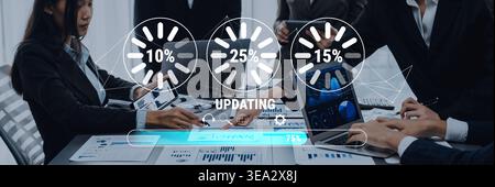 A business team works diligently together, analyzing data and collaborating on project progress with indicators displayed on their technology in a Stock Photo