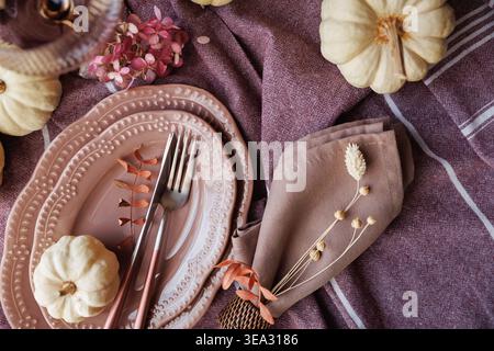 Autumn-inspired Thanksgiving table with pumpkins and rustic charm Stock Photo