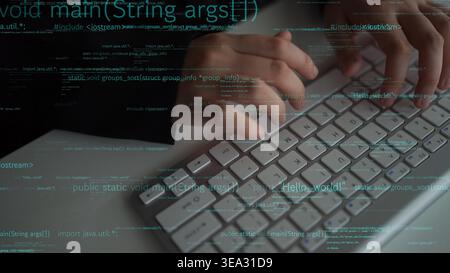 A close-up view of a programmer hands typing on a computer keyboard, creating code for software development. The image symbolizes technology and Stock Photo