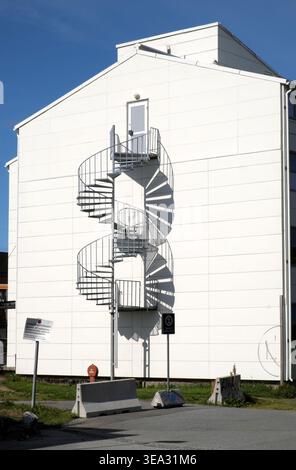 Spiral stair fire escape, with its shadow, on the gable end of a building, Tromso, Troms, Norway. Stock Photo