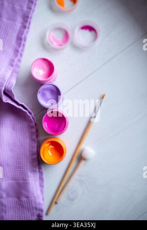Paints in jars, acrylic paint and brushes on a white background Stock Photo
