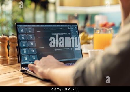 Man engaging with AI-powered chatbot, everyday life use of artificial intelligence, generative software, autonomous and real-time tools, support problem solving and productivity at home. Stock Photo