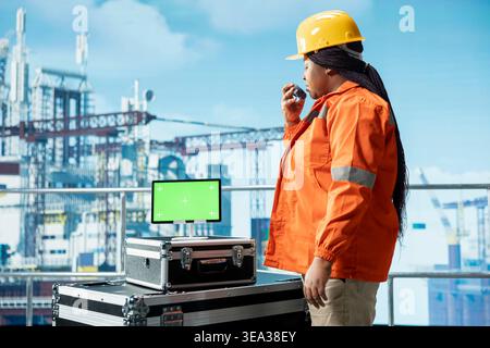 Isolated screen tablet used by offshore platform worker managing maintenance systems, scheduling equipment fixing. Barge engineer oversees structural integrity of drilling rig with mockup device Stock Photo
