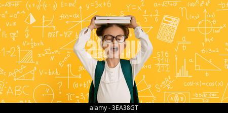 Child Holds Book Above Head With Hands in Classroom Surrounded by Math Symbols and Chalkboard Stock Photo