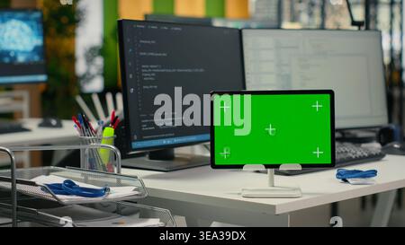 Isolated screen tablet on Silicon Valley startup office desk used to implement neural network algorithms. AI tech company workplace with mockup device used to conduct code reviews, close up Stock Photo