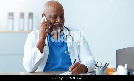 Doctor on the Phone While Taking Notes in a Medical Office Stock Photo
