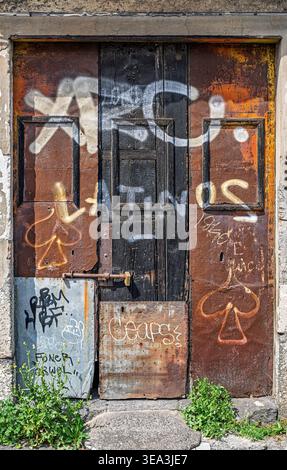 Old locked wooden door with frames and large iron plates, Catania, Sicily, Italy; Stock Photo