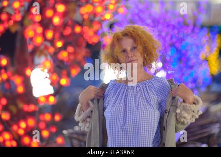 Portrait of a woman in artistic neon lighting on a night city street Stock Photo