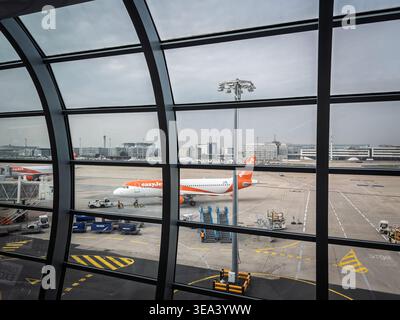 PARIS, FRANCE - MARCH 6, 2026: easyJet aircraft on the apronof Paris Charles de gaulle airport, with ground service vehicles, airport equipment. Easyj Stock Photo