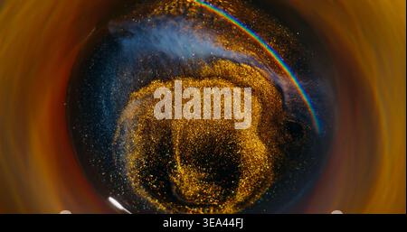 Blur glitter wave. Splatter texture. Defocused golden neon blue color paint swirl sparkling rainbow circling on abstract background. Stock Photo