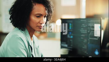 Computer, programmer and research with woman in office for coding, cyber security or cloud computing. Programming, reading and developer with person Stock Photo