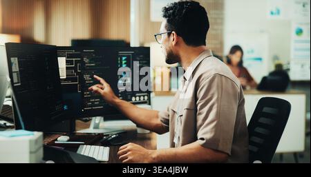 Computer, code and programmer with business man in office for web developer, research or database. Software engineer, firewall update and coding Stock Photo
