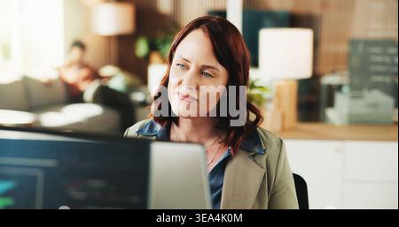 Computer, reading and programmer with business woman in office for web developer, code or database. Software engineer, firewall update and coding Stock Photo