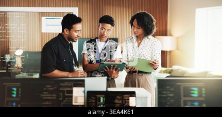 Tablet, coding and team with business people in office for programmer review, research and project. Web developer, software engineer and tech workshop Stock Photo