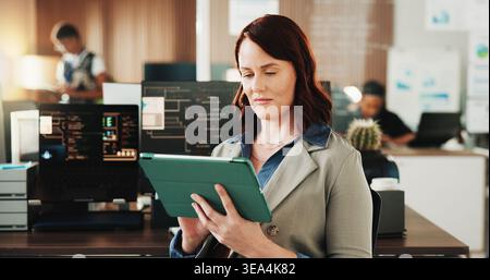 Tablet, programmer and research with woman in office for coding, cyber security and cloud computing. Programming, reading and developer with employee Stock Photo