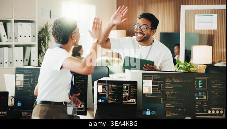 High five, programmer and tablet with business people in office for app developer, support and database. It engineer, software launch success and Stock Photo