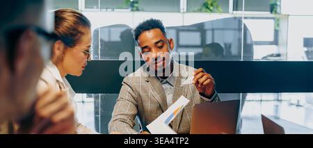 Financial advisory meeting black financial advisor and asian client Stock Photo