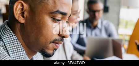 Dedicated analyst thoroughly assesses KPI data in office environment Stock Photo