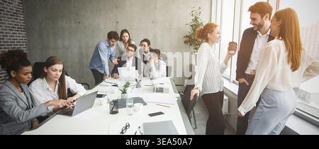 Break in office. Business colleagues talking and discussing work Stock Photo