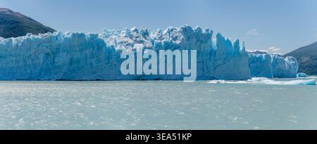 large size panoramic landscape with jagged ice formations of vertical cliffs at glacier south-eastern side, shot in bright summer light at Perito More Stock Photo
