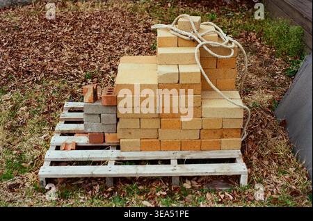 Stacked Fire Bricks on a Wooden Pallet Outdoors Stock Photo