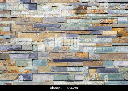 Stone wall texture with stacked slate tiles. Natural pattern background for construction and design. Stock Photo