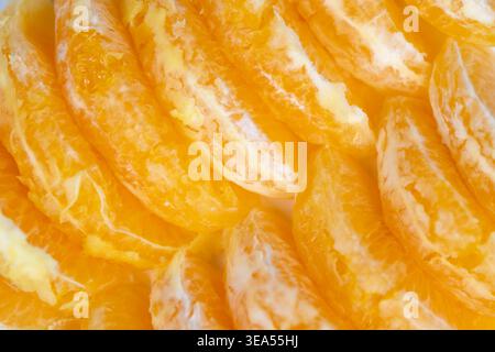 Rows of orange slices forming clean minimal pattern, soft shadows and highkey aesthetic create versatile backdrop for packaging, branding, or editoria Stock Photo
