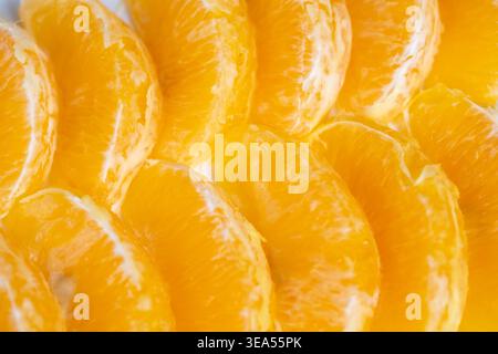 Fresh orange segments arranged as repeating pattern for packaging and label design, highenergy branding asset with bold color and wholesome product as Stock Photo