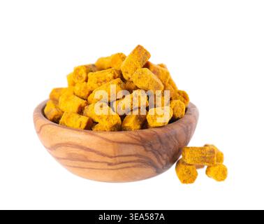 Bee bread isolated on white background. Pile of granules bee bread or perga in wooden bowl. Clipping path Stock Photo