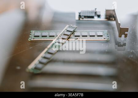 Close-up of RAM memory modules and PCIe card on reflective surface with shallow depth of field Stock Photo