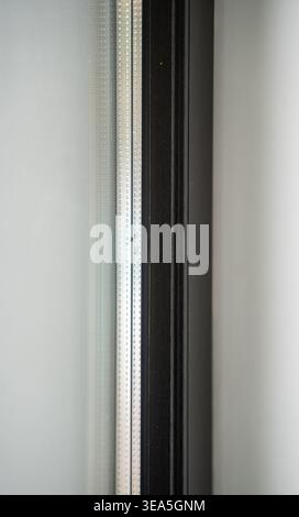 Window frame detail with patterned glass creating a modern minimalist architectural background Stock Photo