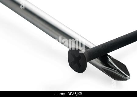 Construction screw and screwdriver on white isolated background Stock Photo