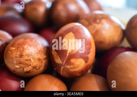 Naturally dyed Easter eggs in rustic arrangement for seasonal holiday background use. Stock Photo