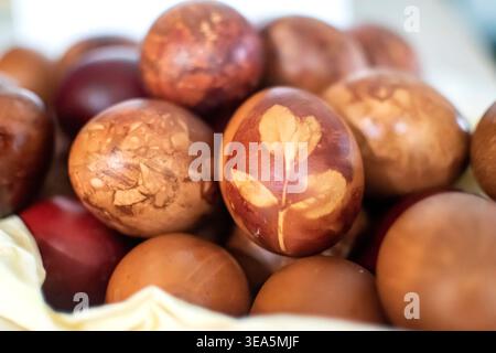Naturally dyed Easter eggs in rustic arrangement for seasonal holiday background use. Stock Photo