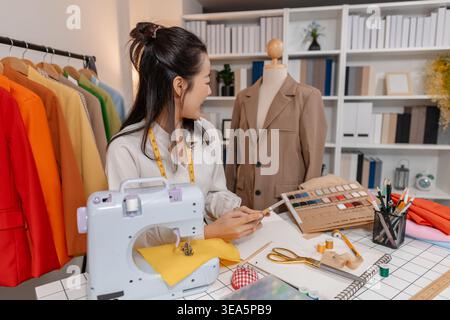 Clothing designer working with sewing machine while developing apparel design and preparing garments in fashion studio, focusing on craftsmanship and Stock Photo