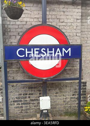 London Underground  roundel sign for Chesham station, Metropolitan line Buckinghamshire UK. Iconic red, white and blue TFL sign mounted on a pole Stock Photo