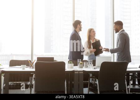 Business colleagues having conversation during break in office Stock Photo