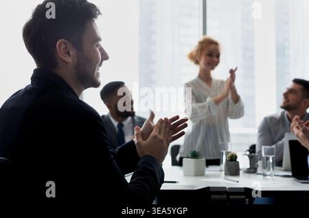 Business seminar. Audience applauding speaker in office Stock Photo
