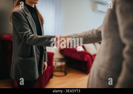 Business team handshake sealing a professional agreement between colleagues in a modern office setting Stock Photo