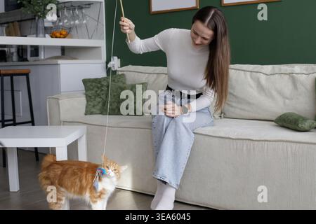 Attractive woman with cat playing and having fun at home Stock Photo