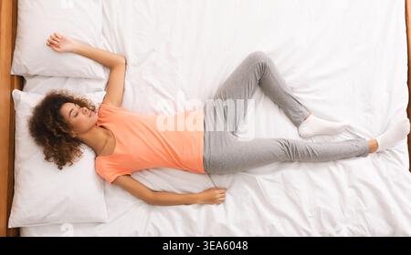 African-american woman enjoying her sleep, top view Stock Photo