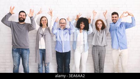 Cheerful funny millennials posing with different gestures Stock Photo