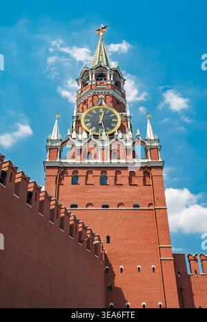Moscow, Russia - June 23, 2021: Spasskaya Tower of Moscow Kremlin stands tall against a brilliant blue sky with white clouds Stock Photo