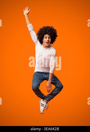 Funny young black man jumping on the air Stock Photo