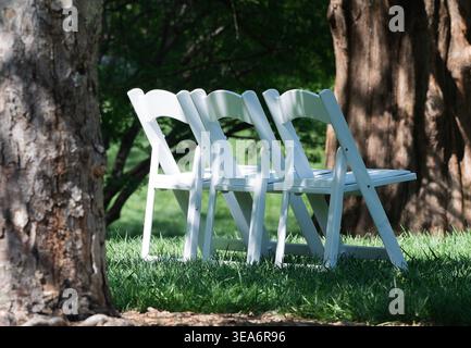 Wooden folding chairs in a park setting Stock Photo